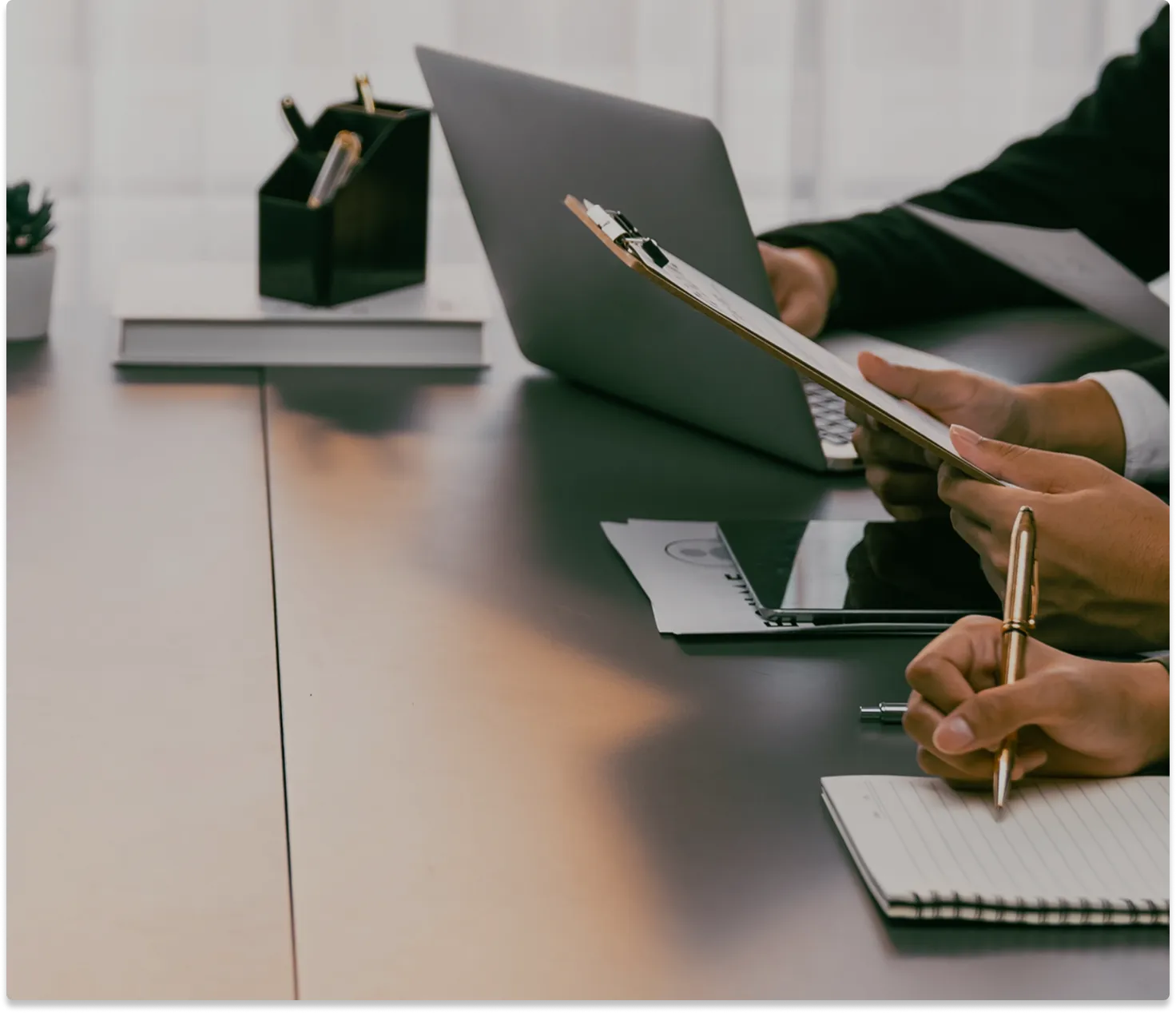 HR manager reviewing candidate documents and offer paperwork during a recruitment process meeting.
